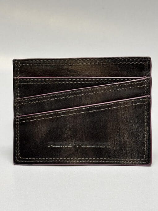 the outside of the wallet is black with purple lining and four card slots
