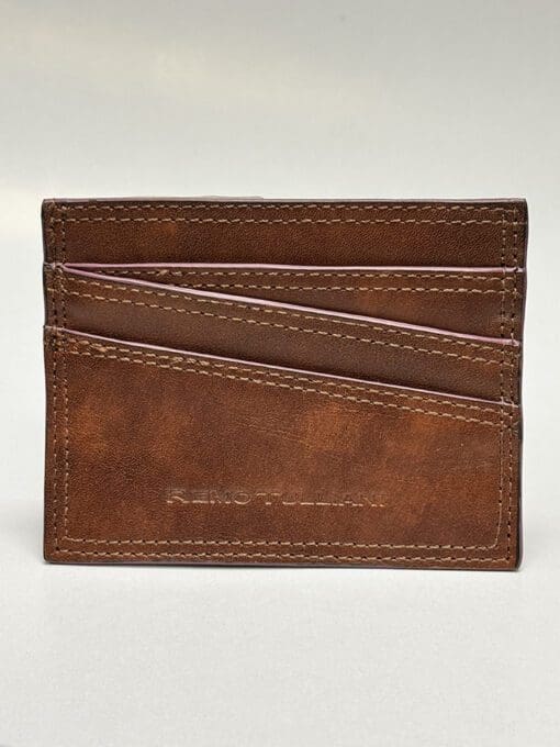 The outside of the wallet is brown with purple lining and four card slots