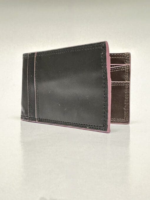 The outside of the wallet is black with purple lining and two card slots