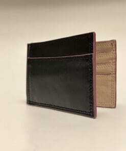 Outside of wallet is black with purple edges and tan inside.