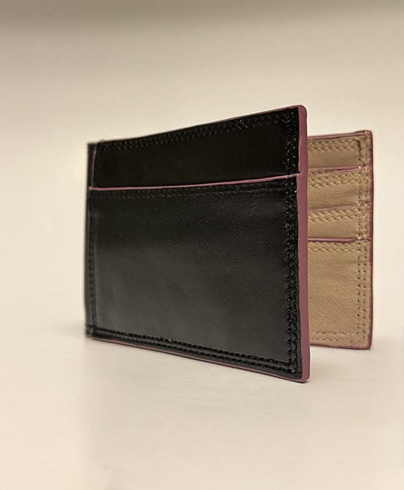 Outside of wallet is black with purple edges and tan inside.